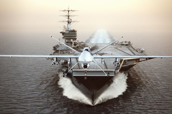 Military Drone aircraft launching from an aircraft carrier on a strike mission
